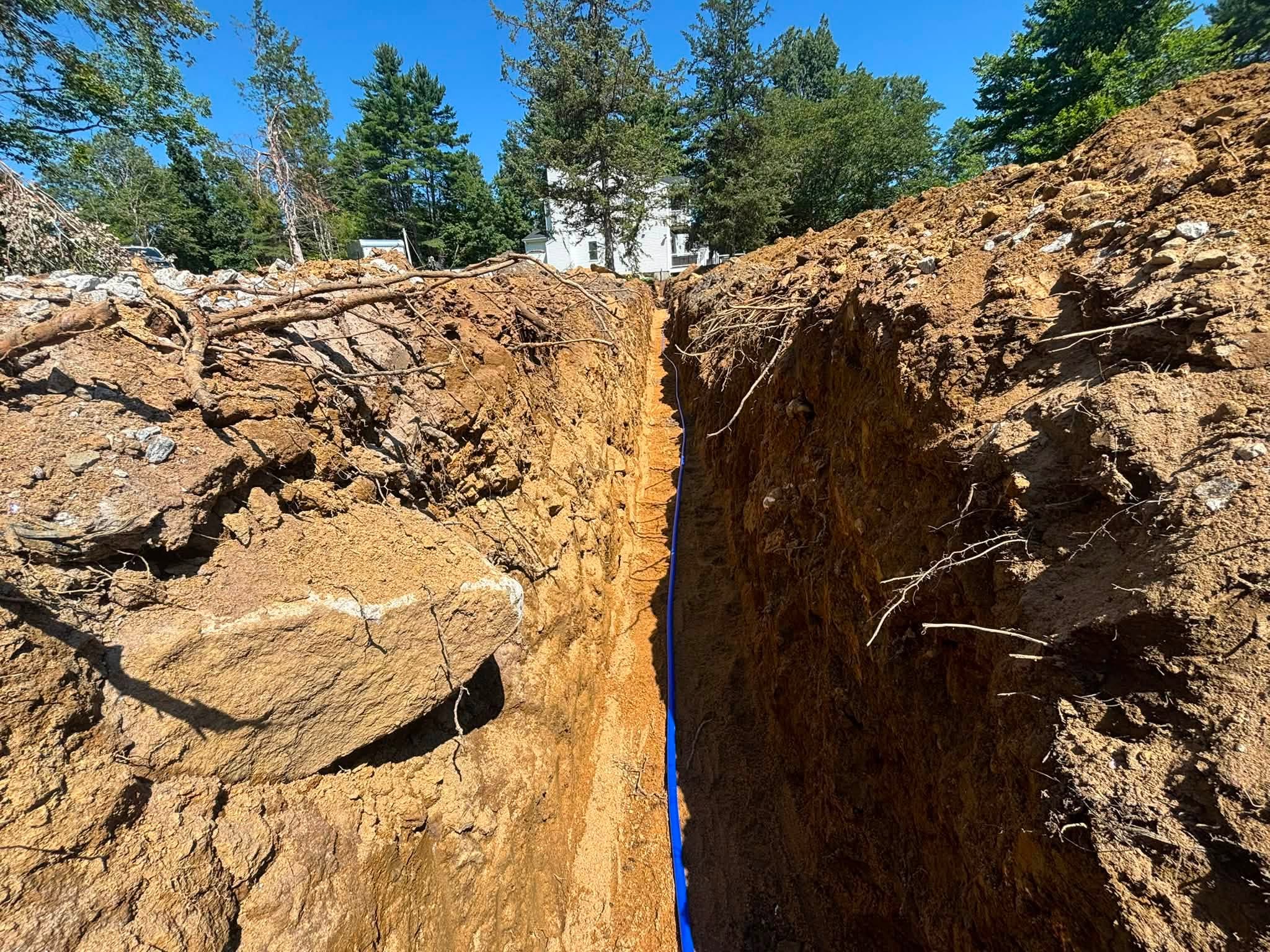 Water line being laid in sand bed — 200-foot utility trench